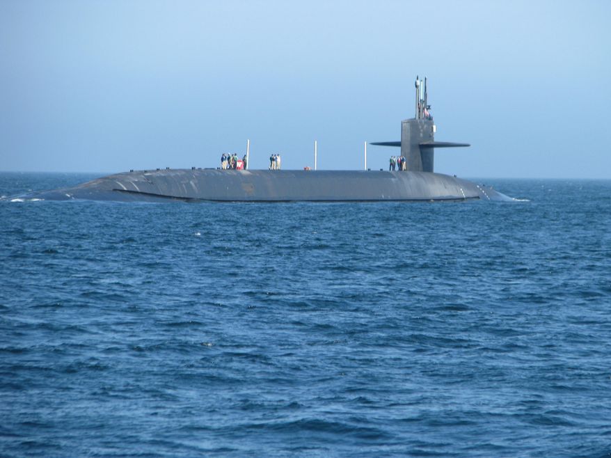 In a July 9, 2008 photo, the 560-foot nuclear submarine USS Nebraska surfaces near Seattle after 100 days on patrol beneath the waves. (Mike Konz/The Daily Hub via AP)