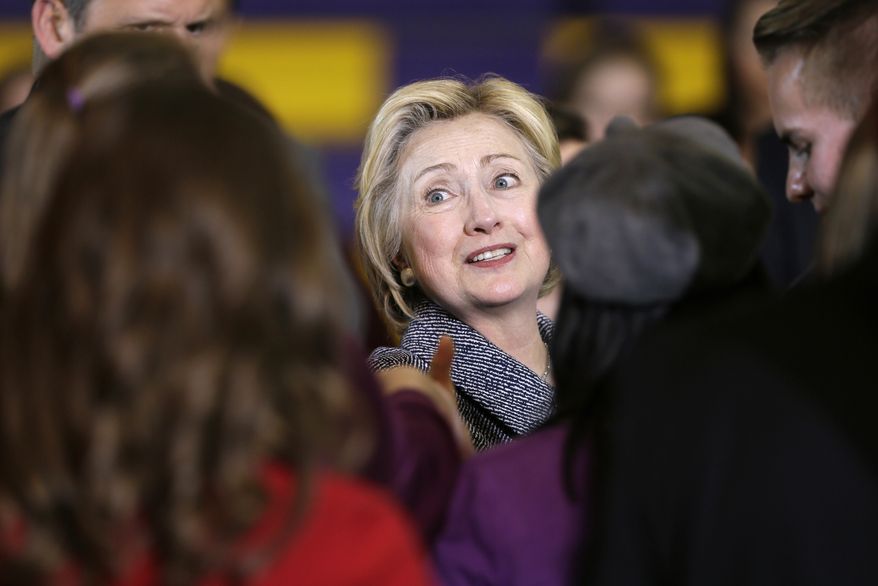 Democratic presidential candidate Hillary Clinton greets supporters during a town hall meeting at Keota High School, Tuesday, Dec. 22, 2015, in Keota, Iowa. (AP Photo/Charlie Neibergall)