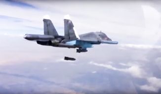 In this Dec. 9, 2015 file photo made from video footage provided by the Russian Defense Ministry, a Russian Su-34 bomber drops bombs on a target. A new report by a human rights watchdog group accuses Russia of using cluster munitions and unguided bombs on civilian areas in Syria in attacks that it says have killed hundreds of people. (Russian Defense Ministry Press Service via AP, File)