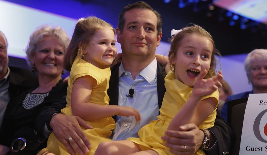 Republican presidential candidate and Sen. Ted Cruz holds his daughters Catherine (left) and Caroline at a rally in Des Moines, Iowa, on Aug. 21, 2015. (Associated Press)
