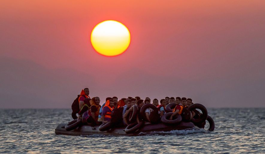 Migrants on a dinghy arrives at the southeastern island of Kos, Greece, after crossing from Turkey, Thursday, Aug. 13, 2015. Greece has become the main gateway to Europe for tens of thousands of refugees and economic migrants, mainly Syrians fleeing war, as fighting in Libya has made the alternative route from north Africa to Italy increasingly dangerous. (AP Photo/Alexander Zemlianichenko, File)