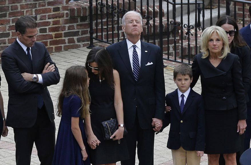Vice President Joe Biden, center, pauses alongside his family as they to enter a visitation for his son, former Delaware Attorney General Beau Biden, Thursday, June 4, 2015, at Legislative Hall in Dover, Del. Standing with Biden are his son Hunter, from left, granddaughter Natalie, daughter-in-law Hallie, grandson Hunter and wife Jill. Beau Biden died of brain cancer Saturday at age 46. (AP Photo/Patrick Semansky, Pool, File)
