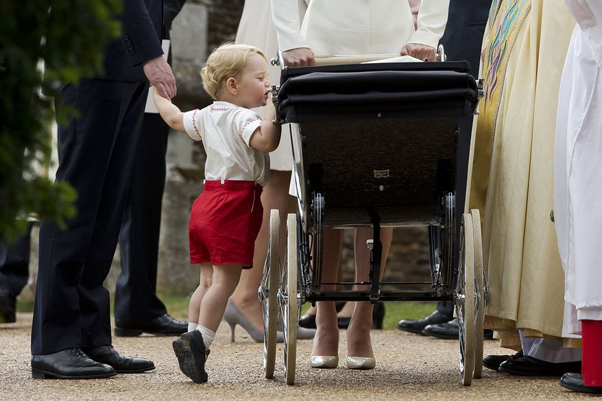 Britain's Prince George gets up on tip-toes to peek into the pram of his sister Princess Charlotte flanked by his parents Prince William and Kate the Duchess of Cambridge as they leave after Charlotte's Christening at St. Mary Magdalene Church in Sandringham, England, Sunday, July 5, 2015. (AP Photo/Matt Dunham, Pool, File)