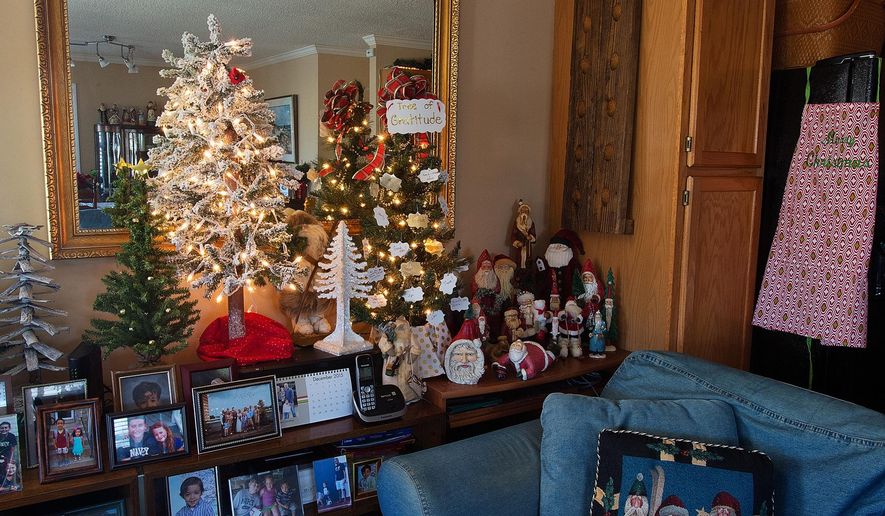 ADVANCED FOR RELEASE THURSDAY, DECEMBER 24, 2015 In an area of the family room named 'William's Woods' sits a 'tree of gratitude' (right) on Wednesday, Dec. 16, 2015 where High Rock Lake homeowners Patsie and Bill Baker encourage people to write on a card ornament something they are thankful for and then hang it on the tree. (Donnie Roberts/The Lexington Dispatch via AP)