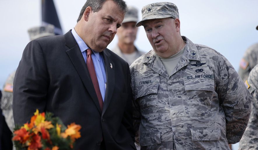 FILE - In this Sept. 28, 2014 file photo, New Jersey Gov. Chris Christie, left, listens to New Jersey Adjutant General Brig. Gen. Michael Cunniff, right, as they review troops during the New Jersey National Guard's annual Military Review in Sea Girt, N.J. On Tuesday, Dec. 22, 2015, Cunniff informed Gov. Chris Christie that he passed a fitness test, meeting a deadline imposed by the governor to shape up. (AP Photo/Mel Evans, File)