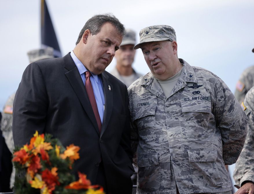 FILE - In this Sept. 28, 2014 file photo, New Jersey Gov. Chris Christie, left, listens to New Jersey Adjutant General Brig. Gen. Michael Cunniff, right, as they review troops during the New Jersey National Guard's annual Military Review in Sea Girt, N.J. On Tuesday, Dec. 22, 2015, Cunniff informed Gov. Chris Christie that he passed a fitness test, meeting a deadline imposed by the governor to shape up. (AP Photo/Mel Evans, File)