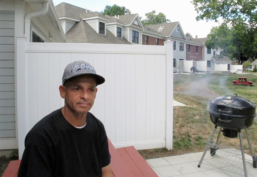 Luis Vazquez, a Navy veteran who was homeless off and on for 10 years, sits outside his home in a veterans housing complex in Newington, Connecticut. Twelve cities, three counties and one state, Virginia, say they have ended veteran homelessness altogether. Connecticut says it has ended chronic homelessness. (Associated Press)