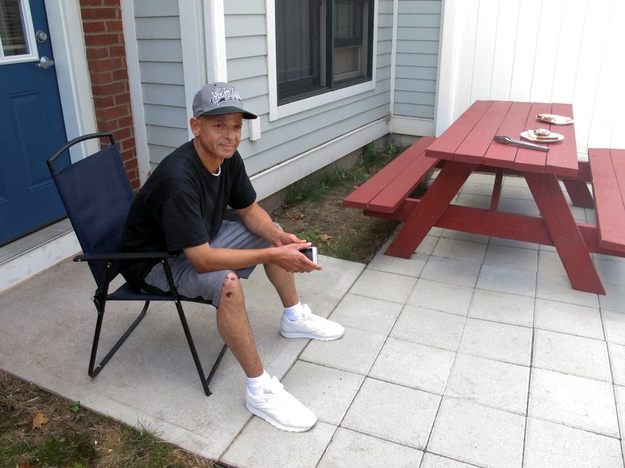 Luis Vazquez, a 49-year-old Navy veteran who was homeless off and on for 10 years, sits outside his home in a veterans' housing complex Thursday, Aug. 27, 2015, in Newington, Conn. U.S. Veterans Affairs Secretary Robert McDonald and Connecticut officials were at the housing complex Thursday to announce that the state is the first in the country to end chronic homelessness among veterans. (AP Photo/Dave Collins)