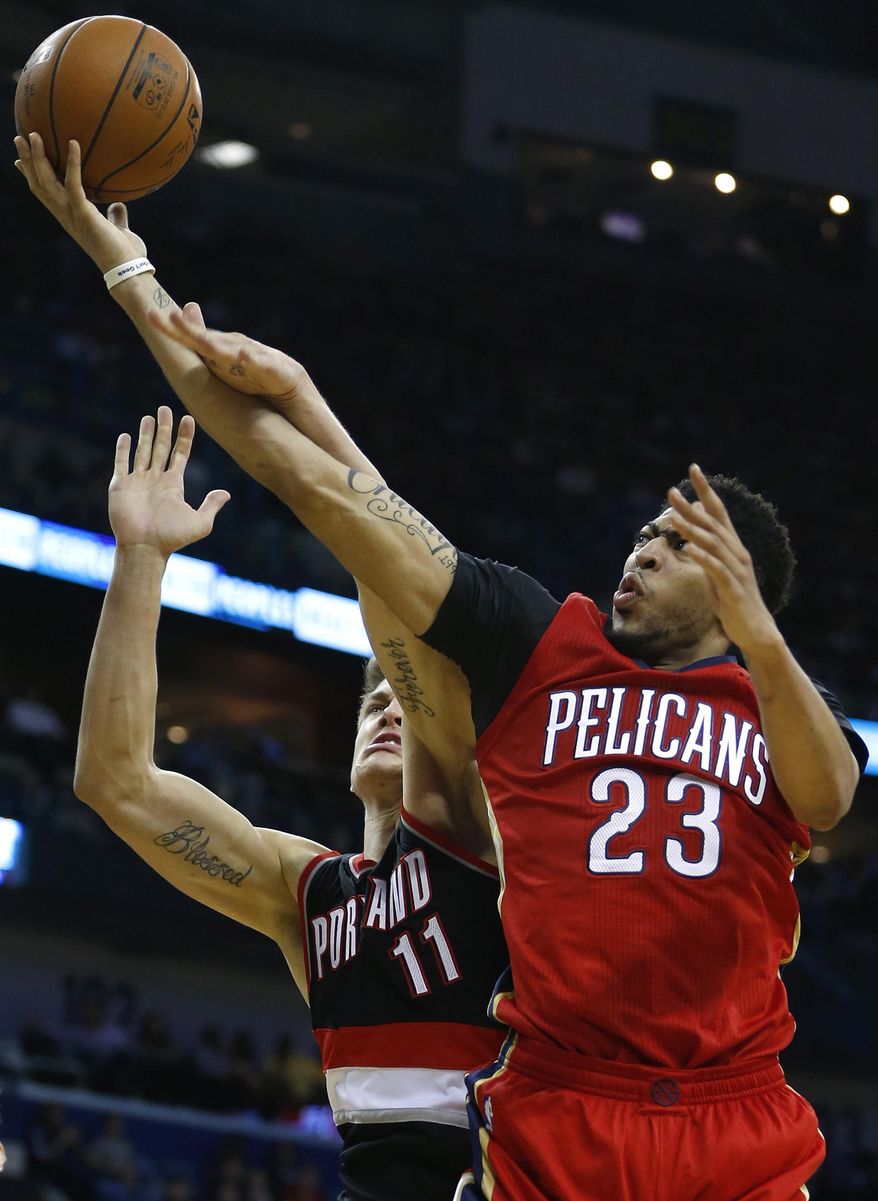 FILE - In this Wednesday, Dec. 23, 2015 file photo, New Orleans Pelicans forward Anthony Davis (23) drives to the basket against Portland Trail Blazers forward Meyers Leonard (11) during the second half of an NBA basketball game in New Orleans. Several players will make their debut under the Christmas lights, including New Orleans star Davis. (AP Photo/Jonathan Bachman, File)
