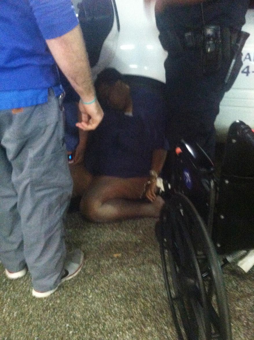 In this Monday, Dec. 21, 2015 photo provided by the family of Barbara Dawson, Dawson lies on the ground after collapsing on the floor in Blountstown, Fla. Dawson collapsed while being escorted in handcuffs from the hospital, where she sought treatment for breathing difficulties, Blountstown Police Chief Mark Mallory said. She was arrested for disorderly conduct and trespassing when she refused multiple requests to leave, Mallory said. (Courtesy of the family of Barbara Dawson via AP)
