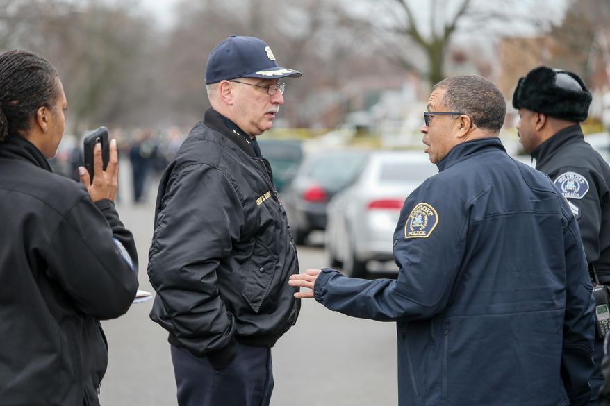 Dearborn Police Chief Ronald Haddad, left, and Detroit Police Chief James Craig speak at the scene of a fatal shooting of an unarmed man involving a Dearborn Police officer on the westside of Detroit on Wednesday, Dec. 23, 2015. An unarmed black man who was fatally shot by suburban Detroit police suffered from mental illness and wasn't a threat to officers, his mother said Thursday, Dec. 24, 2015. (Kimberly P. Mitchell/Detroit Free Press via AP)