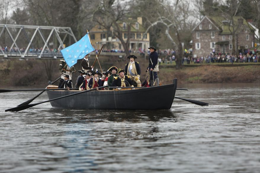 John Godzieba, standing second from right, portraying Gen. George Washington, looks towards New Jersey from a Durham boat during a re-enactment of Washington's historic crossing of the Delaware River, Friday, Dec. 25, 2015, in Washington Crossing, Pa. (AP Photo/ Joseph Kaczmarek)