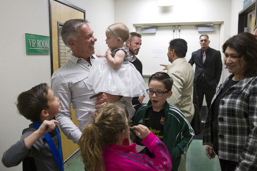 Pastor Paul Goulet holds granddaughter Brielle Parker, 11-months, between services at the International Church of Las Vegas, Sunday Dec. 13, 2015. Goulet, leader for 23 years of the nondenominational International Church of Las Vegas, was announced Dec. 1 as state campaign chairman for Republican presidential candidate Ben Carson. The selection marked the culmination of a gradual political awakening for Canadian-born Goulet, who became an American citizen only half a year ago after living in the United States for decades. (Steve Marcus/Las Vegas Sun via AP)