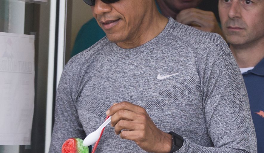 President Barack Obama walks out of Island Snow with shaved ice during a family vacation on Sunday, Dec. 27, 2015, in Kailua, Hawaii. (AP Photo/Evan Vucci)