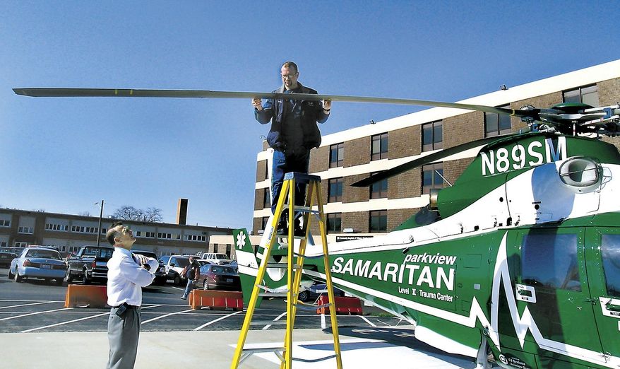 In this Wednesday, April 14, 2004, file photo, Parkview Samaritan helicopter pilot Brad Wilson checks the rotor blade for damage after being struck by a bird while flying, just one mile from Community Hospitals of Williams County, in Bryan, Ohio, the destination landing pad to transport a patient. Reports of helicopter bird strikes are up dramatically in recent years, including incidents that damage the aircraft and create the potential for crashes, according to the Federal Aviation Administration. In 2013, there were 204 reported helicopter bird strikes, a 68 percent increase from 2009 when there were 121 reports and an increase of over 700 percent since the early 2000s, said Gary Roach, an FAA helicopter safety engineer. (Carla Allshouse/The Bryan Times via AP, File) MANDATORY CREDIT