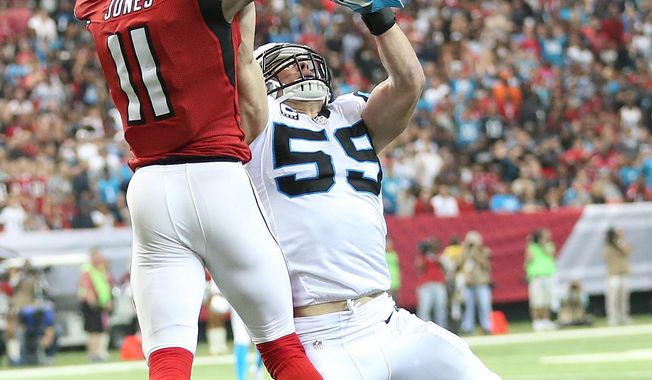 Atlanta Falcons wide receiver Julio Jones (11) makes a catch against Carolina Panthers middle linebacker Luke Kuechly (59) during the second half of an NFL football game, Sunday, Dec. 27, 2015, in Atlanta. Jones scored a touchdown on the play. (AP Photo/John Bazemore)