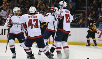 Washington Capitals celebrate a goal by Jay Beagle during the second period of an NHL hockey game against the Buffalo Sabres, Monday Dec. 28, 2015 in Buffalo, N.Y.  Washington won 2-0. (AP Photo/Gary Wiepert)