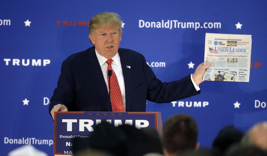 Republican presidential candidate Donald Trump displays a copy of the Union Leader newspaper while addressing an audience during a campaign event Monday, Dec. 28, 2015, in Nashua, N.H. New Hampshire&#39;s largest newspaper, the Union Leader, is the latest target of Trump&#39;s attacks against the news media. (AP Photo/Steven Senne)