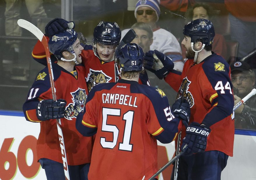 Florida Panthers center Aleksander Barkov (16) is congratulated by center Jonathan Huberdeau (11), defenseman Brian Campbell (51) and defenseman Erik Gudbranson (44) after scoring a goal during the third period of an NHL hockey game against the Montreal Canadiens, Tuesday, Dec. 29, 2015, in Sunrise, Fla. The Panthers defeated the Canadiens 3-1. (AP Photo/Lynne Sladky)
