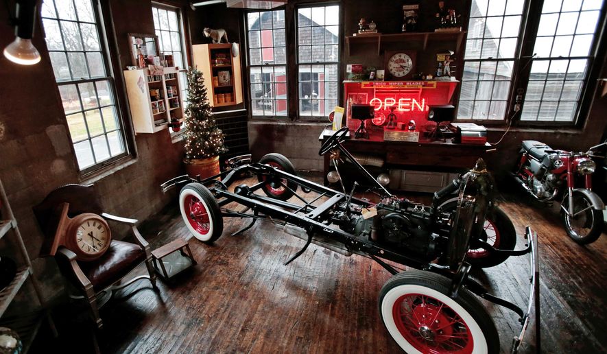 ADVANCE FOR SATURDAY, JAN. 2, 2016- In this photo taken on Tuesday, Dec. 22, 2015, a vintage car frame and other items are displayed at Badger Motor Car Company, a bar and museum in Columbus, Wis. One of the unique draws to the Badger Motor Car Co. is the workshop in the middle of the museum. Visitors can watch as Darvin Frey works on his 1930 Model A pickup truck. (M.P. King /Wisconsin State Journal via AP) MANDATORY CREDIT