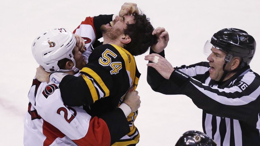 Ottawa Senators right wing Chris Neil (25) and Boston Bruins defenseman Adam McQuaid (54) gouge each other's eyes as they fight during the third period of an NHL hockey game in Boston, Tuesday, Dec. 29, 2015. At right is referee Michael Cormier. (AP Photo/Charles Krupa)