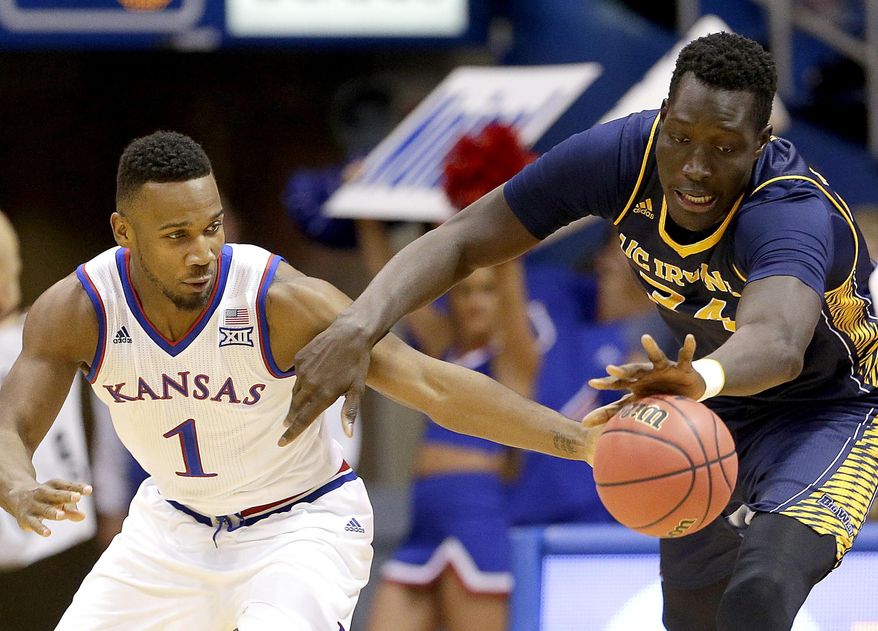 Kansas' Wayne Selden Jr. (1) and UC Irvine's Mamadou Ndiaye (34) chase a loose ball during the first half of an NCAA college basketball game Tuesday, Dec. 29, 2015, in Lawrence, Kan. (AP Photo/Charlie Riedel)