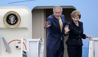 U.S. President George W. Bush and first lady Laura Bush wave as they board Air Force One to depart from RAF Aldergrove in Belfast, Northern Ireland, Monday, June 16, 2008. (AP Photo/Michael Cooper)