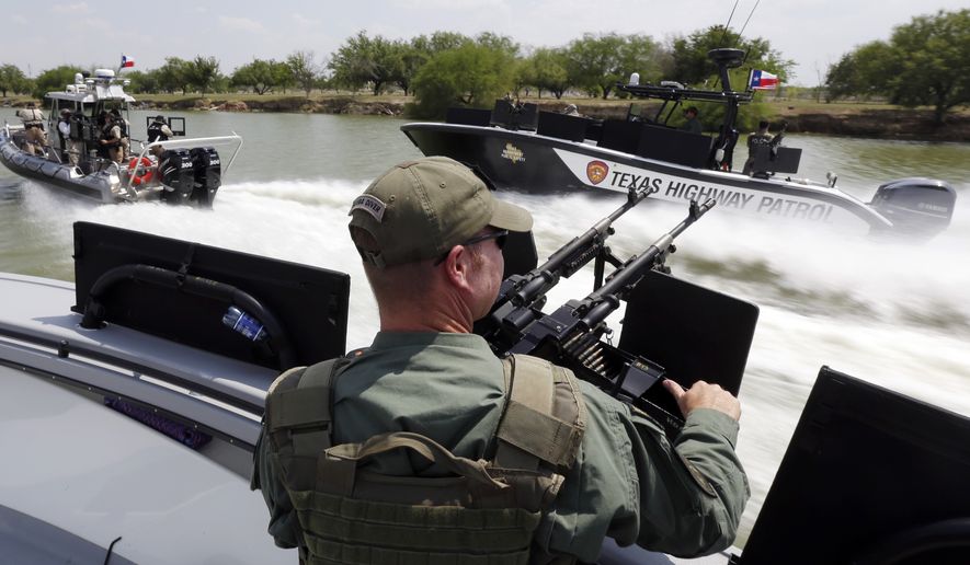 Texas Department of Safety Troopers patrol on the Rio Grand along the U.S.-Mexico border in Mission, Texas, on July 24, 2014. (Associated Press) **FILE**