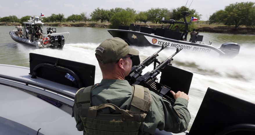 Texas Department of Safety Troopers patrol on the Rio Grand along the U.S.-Mexico border in Mission, Texas, on July 24, 2014. (Associated Press) **FILE**