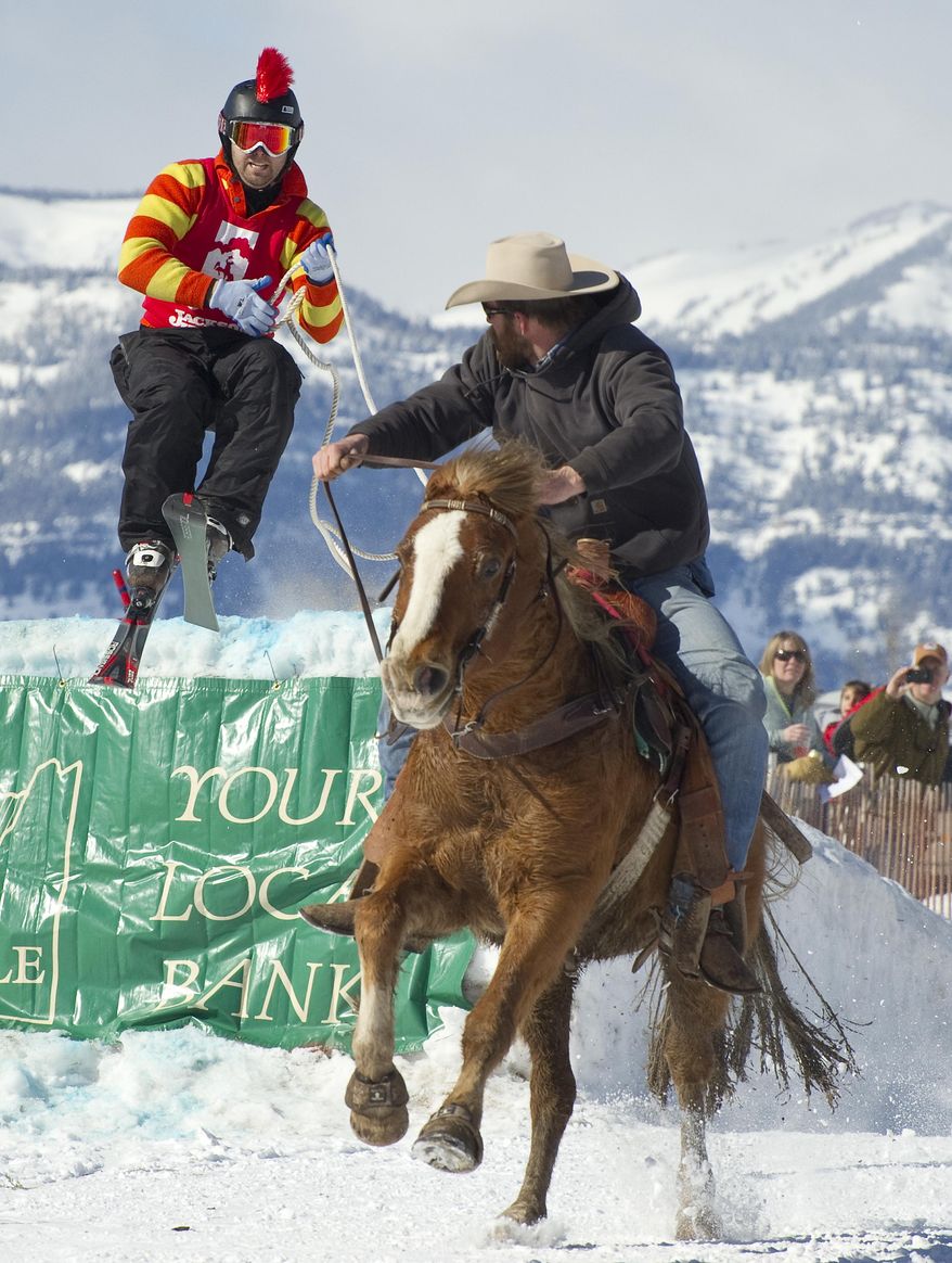 Team Batman and Robin (Robin is the horse) put on a good show as skier Barton Slamey pulls in some rope coming off the second jump. With Brandon Whittington in the saddle, the skijoring team posted a time of 19.6 seconds back in 2013. (Price Chambers/Jackson Hole News and Guide via AP)