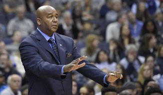 FILE - In this Saturday, Dec. 5, 2015 file photo, Georgetown head coach John Thompson III gestures during the first half of an NCAA college basketball game against Syracuse in Washington. After a conscious effort to test a team that relies heavily on freshmen and sophomores, coach John Thompson III’s Georgetown heads into Big East play with five non-conference losses for just the second time in program history.(AP Photo/Nick Wass, File)