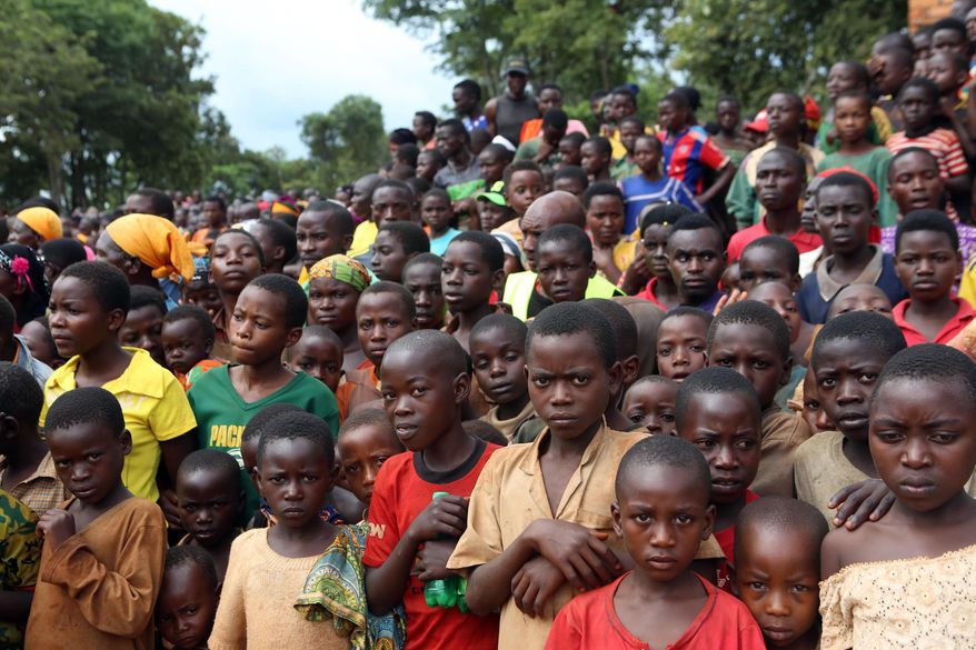 In this photo taken on Tuesday, Dec. 29 2015, Burundian refugees attend a rally addressed by Tanzania Prime Minister Kassim Majaliwa, at Nduta refugee camp in Kigoma, Tanzania. Burundi's President Pierre Nkurunziza threatened on Wednesday, Dec. 30 to fight any African Union peacekeepers imposed on his country, in his most confrontational comments yet on a mounting political crisis. The African Union said this month it was ready to send 5,000 peacekeepers to protect civilians caught up in months of violence, invoking for the first time powers to intervene in a member state against its will. (AP Photo)