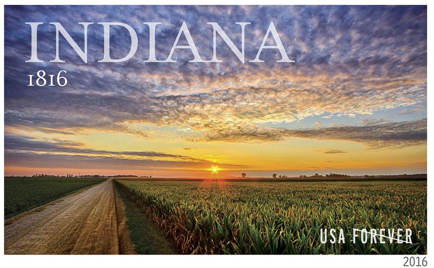 An undated photo provided by the US Postal Service shows a forever stamp to be issued by the The U.S. Postal Service next year honoring then 200th anniversary of Indiana&#x27;s statehood. The image on the stamp showing a brilliant sunset over a northern Indiana cornfield comes from a photograph by 25-year-old Milford native Michael Matti. (US Postal Service via AP)