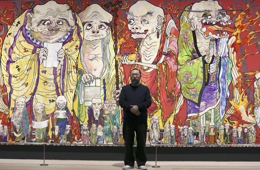 In this Dec. 29, 2015 photo, Japanese artist Takashi Murakami poses in front of part of his work titled "The 500 Arhats" exhibited at Mori Art Museum in Tokyo. In the gentrified kitsch landscape Murakami depicts, 500 grotesque priests parade along dazzlingly colorful giant panels. (AP Photo/Eugene Hoshiko)