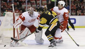 Detroit Red Wings goalie Petr Mrazek (34) deflects a shot by Pittsburgh Penguins center Matt Cullen (7) during the first period of an NHL hockey game, Thursday, Dec. 31, 2015, in Detroit. (AP Photo/Carlos Osorio)