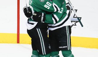 Dallas Stars center Mattias Janmark (13) is congratulated by teammate Jason Spezza following his score during the second period of an NHL hockey game, Thursday, Dec. 31, 2015, in Dallas. (AP Photo/Jim Cowsert)