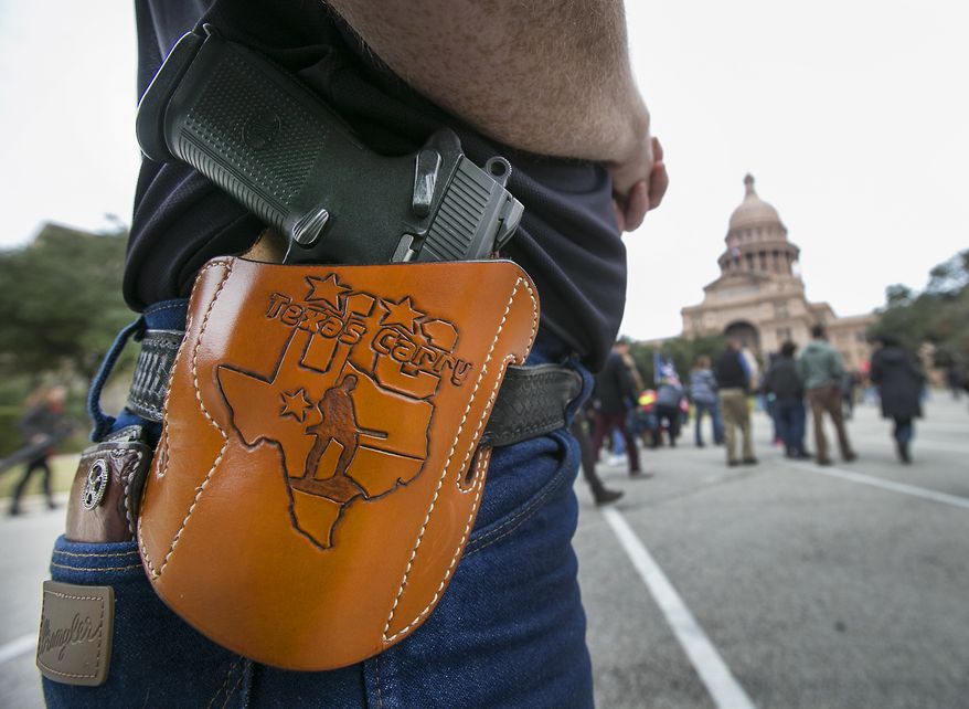 Terry Holcomb,executive director of Texas Carry, happily displays his customized holster as he walks to the Capitol for a rally, Friday, Jan. 1, 2016, in Austin, Texas. (Ralph Barrera /Austin American-Statesman via AP) AUSTIN CHRONICLE OUT, COMMUNITY IMPACT OUT, INTERNET AND TV MUST CREDIT PHOTOGRAPHER AND STATESMAN.COM, MAGS OUT; MANDATORY CREDIT