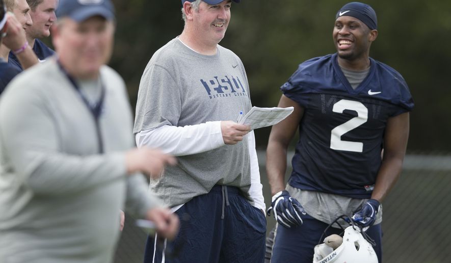New Penn State offensive coordinator Joe Moorhead jokes with tight end Brent Wilkerson (2) during an NCAA college football practice at Fernandina Beach High School, Thursday, Dec. 31, 2015 in Fernandina Beach, Fla. (Joe Hermitt/PennLive.com via AP) MANDATORY CREDIT; MAGS OUT