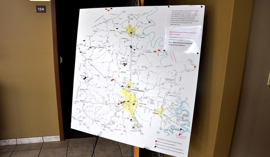 A map on display in the Mercer County Courthouse marks homes that have been affected by the scourge of drugs in that community. (Robin Hart/The Advocate-Messenger via AP)