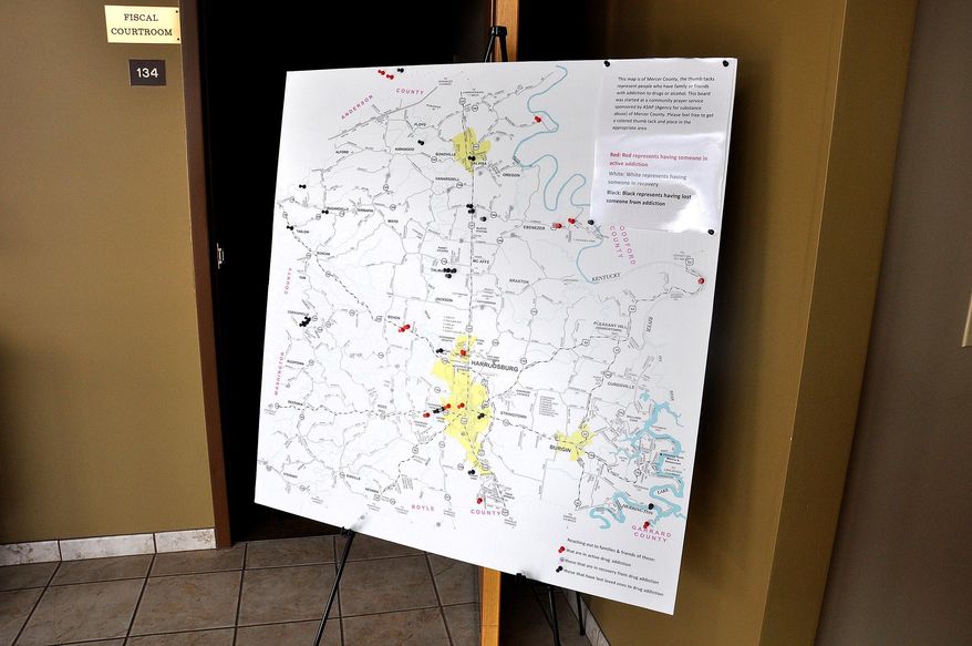 A map on display in the Mercer County Courthouse marks homes that have been affected by the scourge of drugs in that community. (Robin Hart/The Advocate-Messenger via AP)