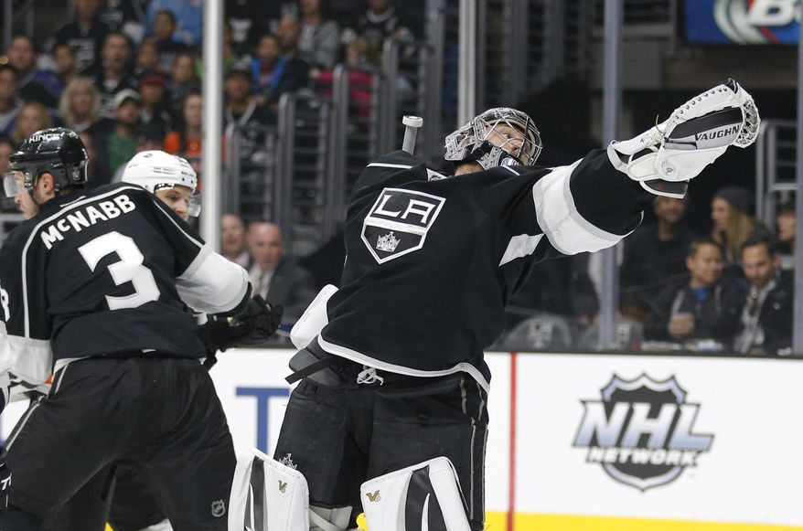 Los Angeles Kings goalie Jonathan Quick reaches for the puck during the first period of an NHL hockey game against the Philadelphia Flyers, Saturday, Jan. 2, 2016, in Los Angeles. (AP Photo/Jae C. Hong)