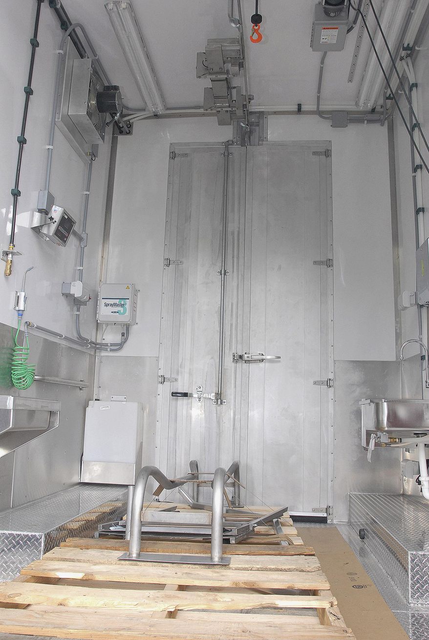 ADVANCE FOR WEEKEND JAN. 2-3, 2016 AND THEREAFTER - This Dec. 23, 2015 photo shows the new mobile slaughterhouse that will be able to process cattle, sheep, goats and hogs in Waimea, Hawaii. Equipped with electric winches and refrigeration, a generator, water supplies for two days and a stainless steel processing room, the unit has almost everything needed to bring the slaughterhouse to the herd. (Laura Shimabuku/West Hawaii Today via AP) MANDATORY CREDIT