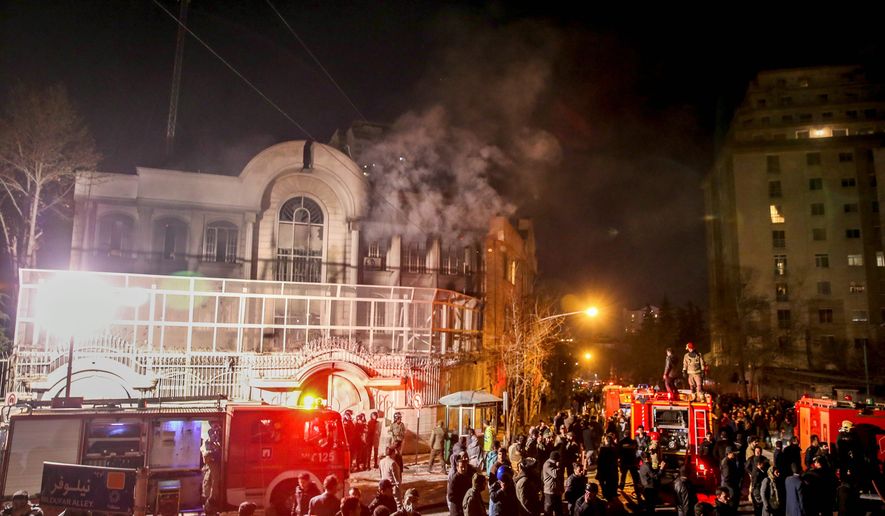Smoke rises as Iranian protesters set fire to the Saudi Embassy in Tehran on Sunday. Protesters were upset over the execution of a Sheikh Nimr al-Nimr in Saudi Arabia. (Associated Press)