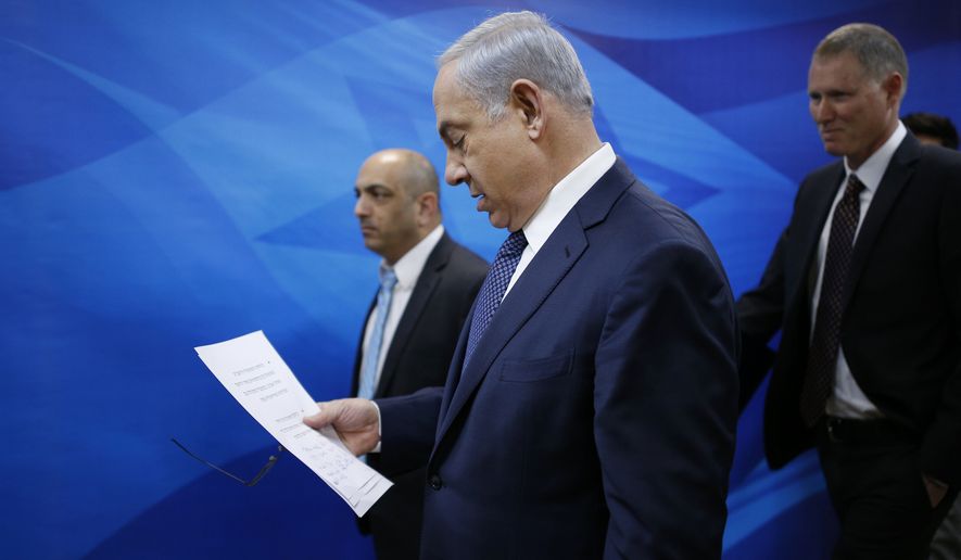 Israeli Prime Minister Benjamin Netanyahu arrives to the weekly cabinet meeting in Jerusalem, Sunday, Jan. 3, 2016. (Amir Cohen /Pool Photo via AP)