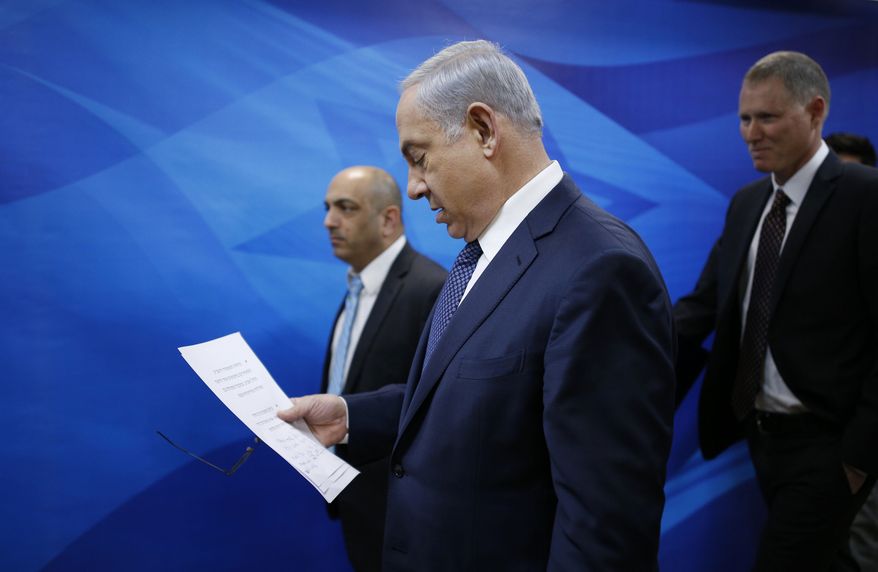 Israeli Prime Minister Benjamin Netanyahu arrives to the weekly cabinet meeting in Jerusalem, Sunday, Jan. 3, 2016. (Amir Cohen /Pool Photo via AP)