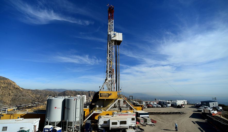 FILE - In this Dec. 9, 2015 file photo, crews work on a relief well at the Aliso Canyon facility above the Porter Ranch area of Los Angeles. The escape of tons of natural gas from under a Los Angeles neighborhood is taking months to stop because of pressure from the leak. The leak at Porter Ranch started in October, and likely won’t be fixed for at least two more months. Officials have relocated several thousand residents who said the stench made them sick. (Dean Musgrove/Los Angeles Daily News via AP, Pool, File)