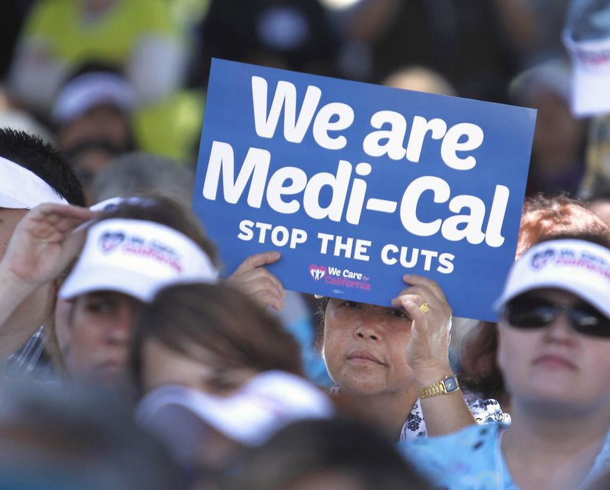 FILE - In this June 4, 2013, file photo, sign-carrying demonstrators representing doctors, hospitals and unionized health care workers rally against cuts in the amount the state pays for Medi-Cal reimbursements, at the Capitol in Sacramento, Calif. Lawmakers will return to the Capitol on Monday, Jan. 4, 2016, facing two unresolved problems from 2015: A $1 billion hole in funding the state's health care program and a $59 billion backlog in road repairs needed over the next decade. Gov. Jerry Brown called special sessions in 2015 to address both issues, but he and lawmakers never reached a deal on paying for either. (AP Photo/Rich Pedroncelli, File)