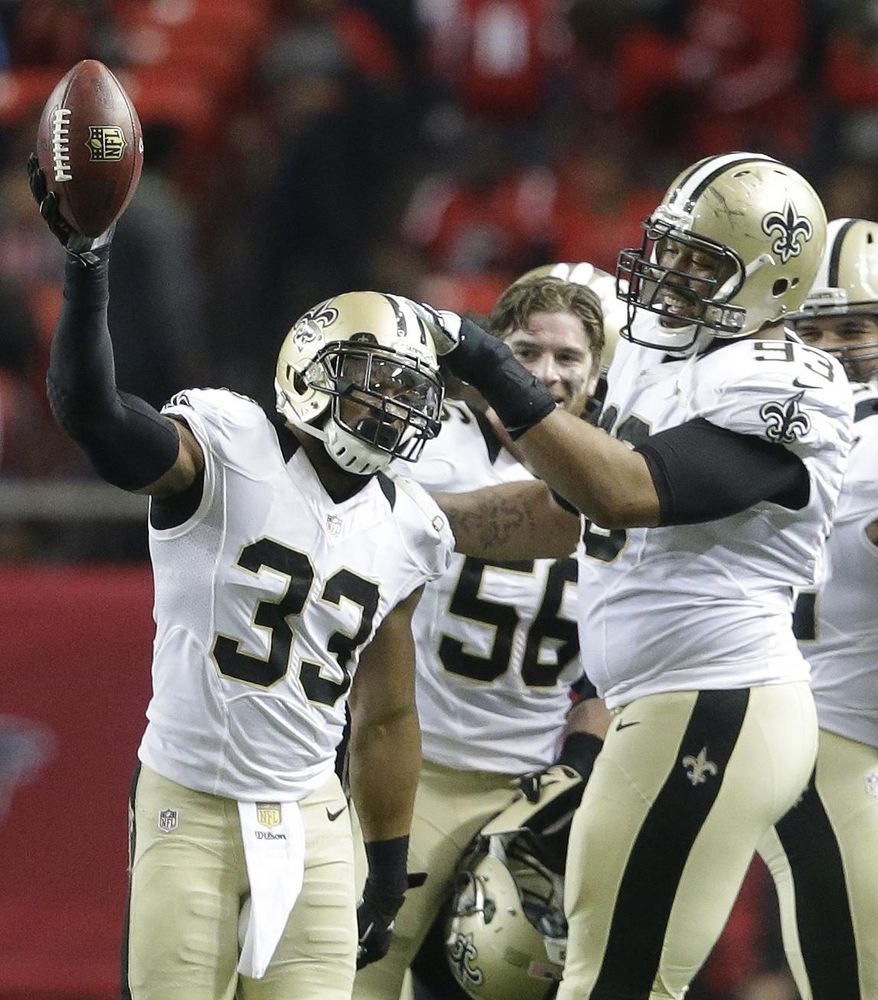 New Orleans Saints strong safety Jamarca Sanford (33) holds up the ball he intercepted against the Atlanta Falcons during the second half of an NFL football game, Sunday, Jan. 3, 2016, in Atlanta. The New Orleans Saints won 20-17. (AP Photo/David Goldman)