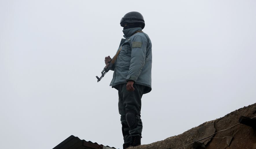 A member of Afghan security forces stands guard at the site of a suicide attack near Kabul International Airport in Kabul, Afghanistan, Monday, Jan. 4, 2016. The attacker killed only himself and harmed no one, said police spokesman Basir Mujahad. (AP Photo/Rahmat Gul)