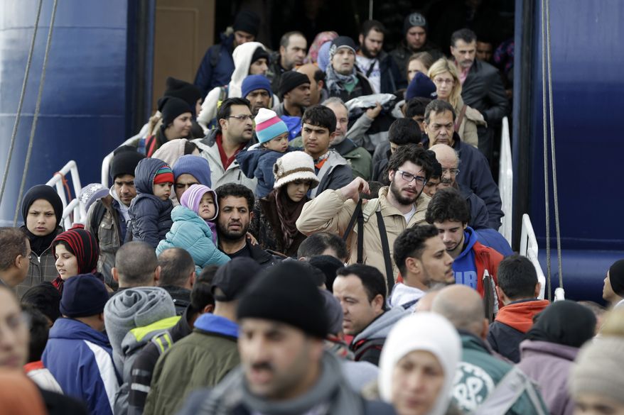 People disembark from a ferry after their arrival from the Greek eastern Aegean islands to the Athens' port of Piraeus, on Monday, Jan. 4, 2016. Greece's coast guard have been rescued hundreds people since the start of the new year in various incidents on the Aeagan Sea as migrants and refugees keep trying to enter the European Union despite the cold and rough seas. (AP Photo/Thanassis Stavrakis)